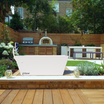 Blizzard cold plunge from Primal Plunges shown in a nice backyard with wood decking