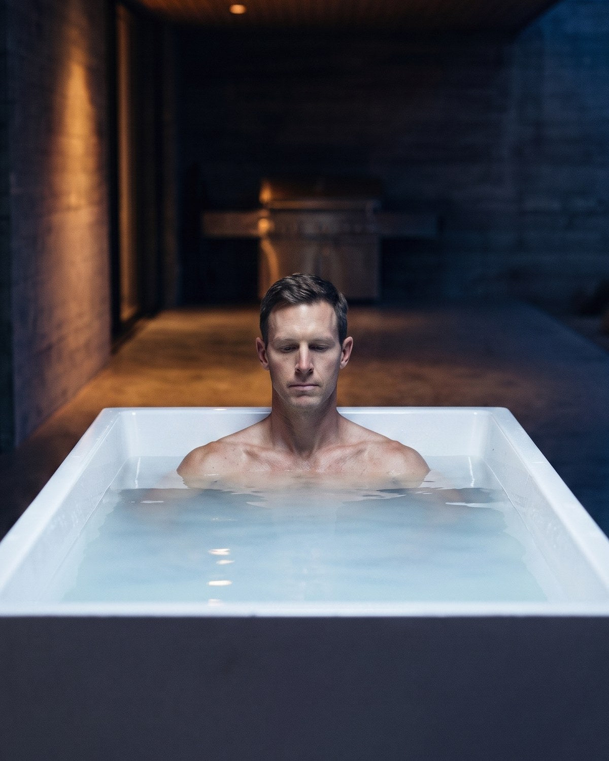 Man sitting chest-deep in a Primal Plunges cold plunge